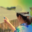 Woman in hardhat near solar array