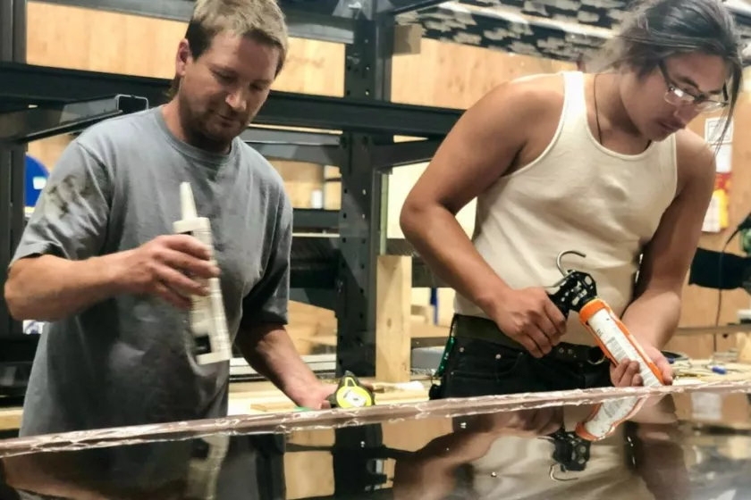 People building solar thermal panels