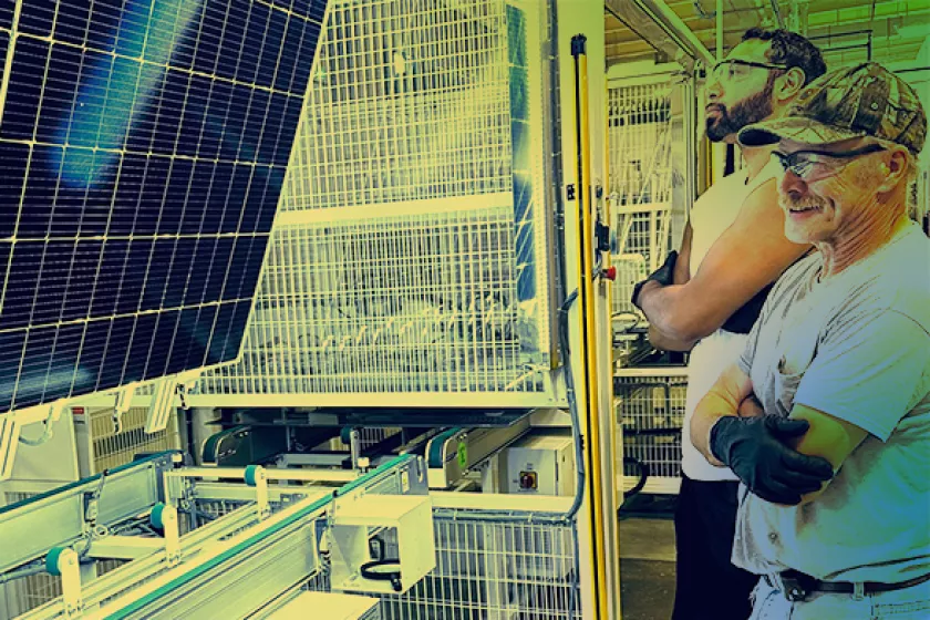 two men looking at a solar panel