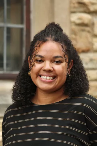 Close up shot of a young multiracial woman smiling.