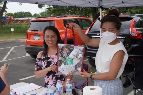 People handing out energy education packets