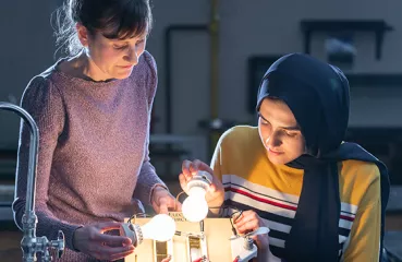 Iman Deriche, senior at Irondale High School, studies solar energy concepts with Andrea Abeln, environmental science teacher and clean energy advocate.