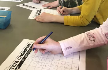 children filling out STEM challenge