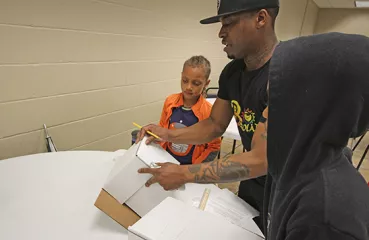 Keith Dent showing camp participants how to create a small solar house