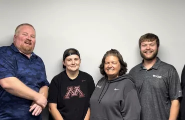 Four members of the TCCAP team stand together smiling. 